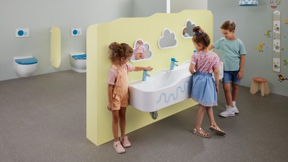 Children play in a sanitary room featuring Geberit Bambini Children play in a sanitary room featuring Geberit Bambini